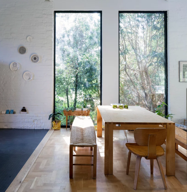 The dining zone is placed by the windows to enjoy the views, there's a brick wall and a sile wooden furniture set The dining zone is placed by the windows to enjoy the views, there's a brick wall and a sile wooden furniture set