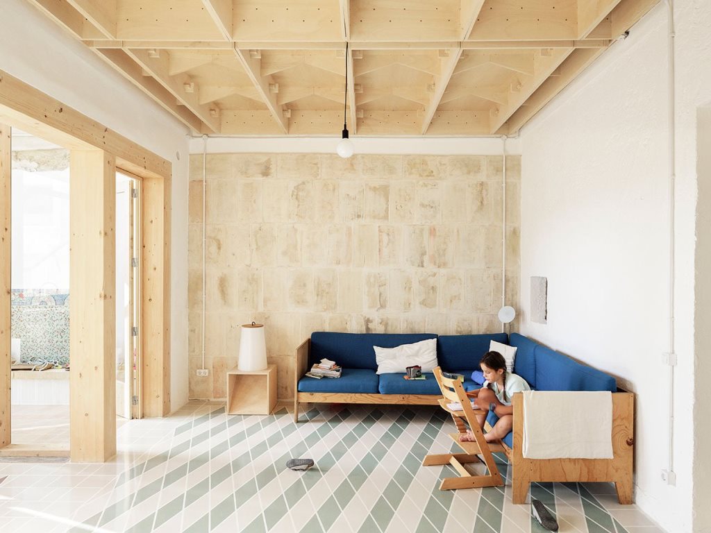 The living room shows off some stylish furniture of plywood and tiles on the floor