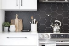 07 a minimalist white kitchen with a matte black hexagon tile backsplash, which is accented with white grout