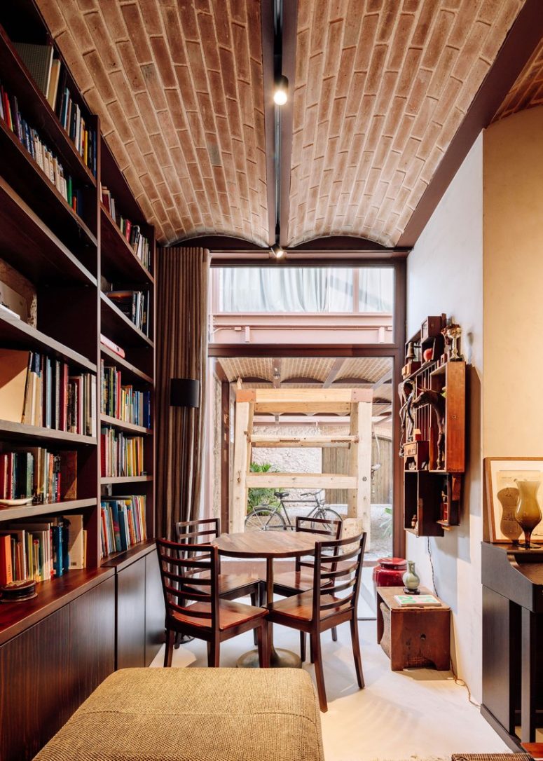 a cozy reading nook with large bookcases Here's a reading nook paired with a breakfast one, with large bookcases, a comfy daybed and a dining set