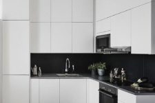 09 a sleek white kitchen with black large scale tile backsplash that contrasts and stands out a lot