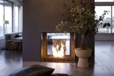 10 a modern double-sided fireplace done of grey concrete looks really spectacular and very chic