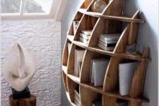 11 a creative semi-circular wooden shelving unit with books and sculptures is art itself