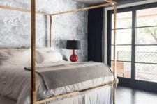 11 a glam brass canopy bed, an echoing chandelier and shiny black floors add chic and glam to the bedroom