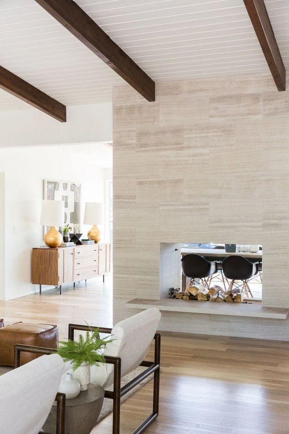 a gorgeous double-sided fireplace, which gives coziness to both the living room and dining space