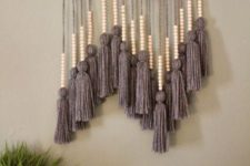 12 a cool boho wall hanging with large grey tassels and wooden beads and a natural branch is very bold