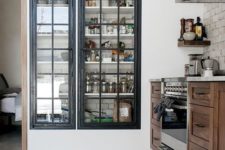 17 a built-in pantry with framed glass doors that keep it in order but allow you see what’s inside