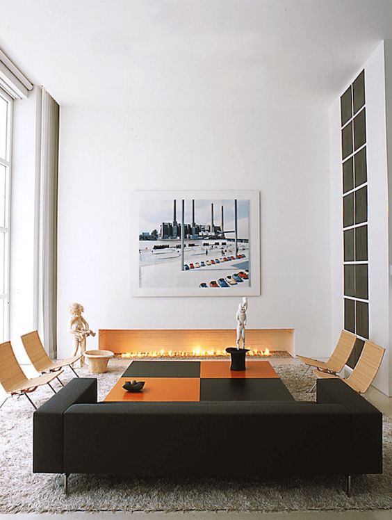 a minimalist living room with a large fireplace enclosed in white and with bricks inside it