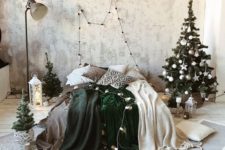 18 a neutral winter bedroom with a small Christmas tree decorated in white and silver, candle lanterns, green and white blankets