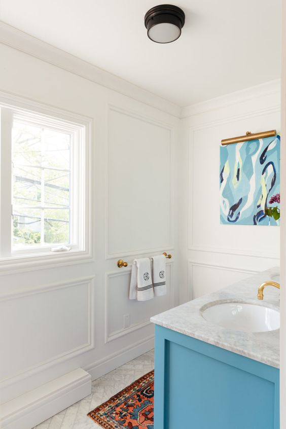 a lively bathroom with crown modling and paneling on the walls is a chic space