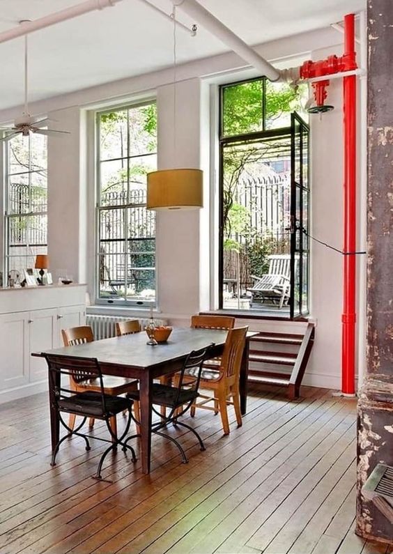 exposed red pipes and white ones make the space feel industrial and more stylish