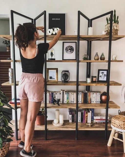an industrial shelving unit of wood and metal is a stylish idea for storage