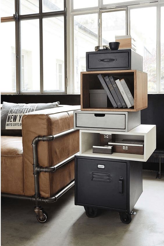 a cool sofa on exposed pipe legs and wheels plus a catchy cabinet with a metal base for an industrial feel