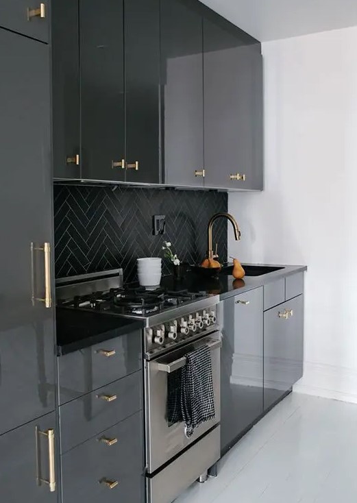 a-glossy-black-kitchen-with-black-chevron-tiles-on-the-backsplash-and-gold-fixtures-is-a-cool-and-chic-idea-in-a-classic-color.jpg
