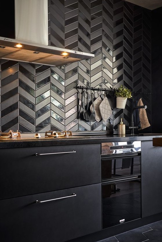 a-metal-black-kitchen-with-black-quartz-countertops-a-black-herringbone-backsplash-with-glossy-and-matte-touches.jpg