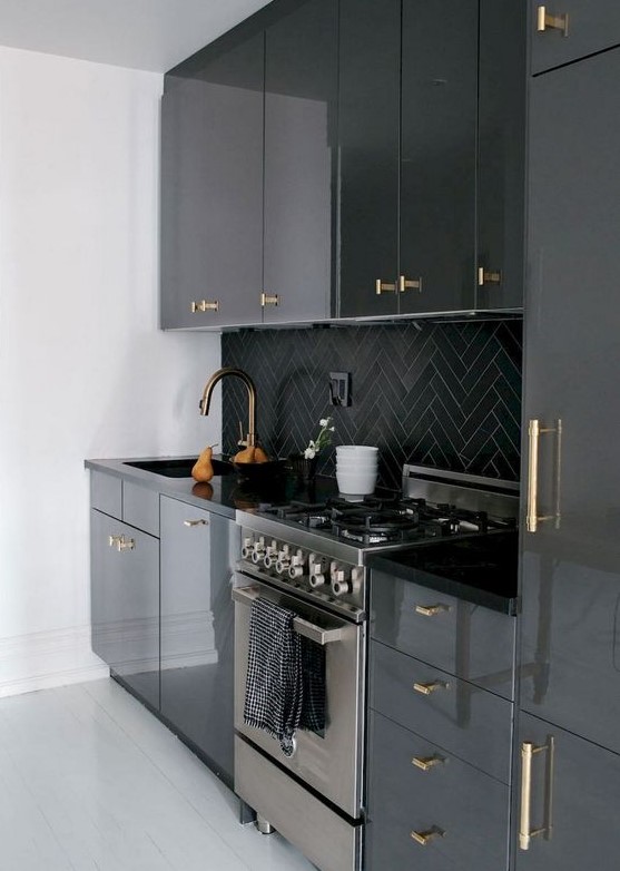 a-modenr-black-kitchen-refreshed-with-white-surfaces-and-with-gold-handles-all-over-that-add-a-touch-of-glam.jpg