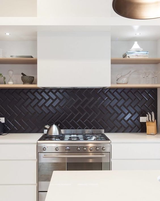 a neutral kitchen with a black herringbone tile backsplash, a hood and open shelves looks bold and contrasting