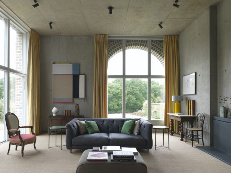 The living room is done with mustard curtains, a mix of refined and modern furniture in muted colors and bright artworks The living room is done with mustard curtains, a mix of refined and modern furniture in muted colors and bright artworks
