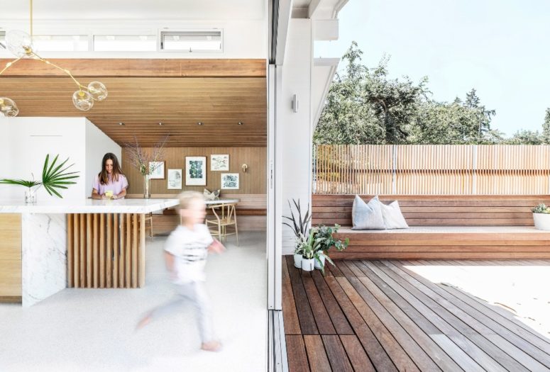 a glazed sliding doors is a good way to combine indoors and outdoors Glazed sliding doors allow entrance to the deck, which is clad with natural wood and indoors and outdoors are interconnected