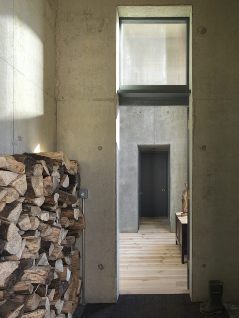 raw concrete is trendy to use in modern decor The house is done with raw concrete inside and wooden floors, and there's a firewood storage in the entrance