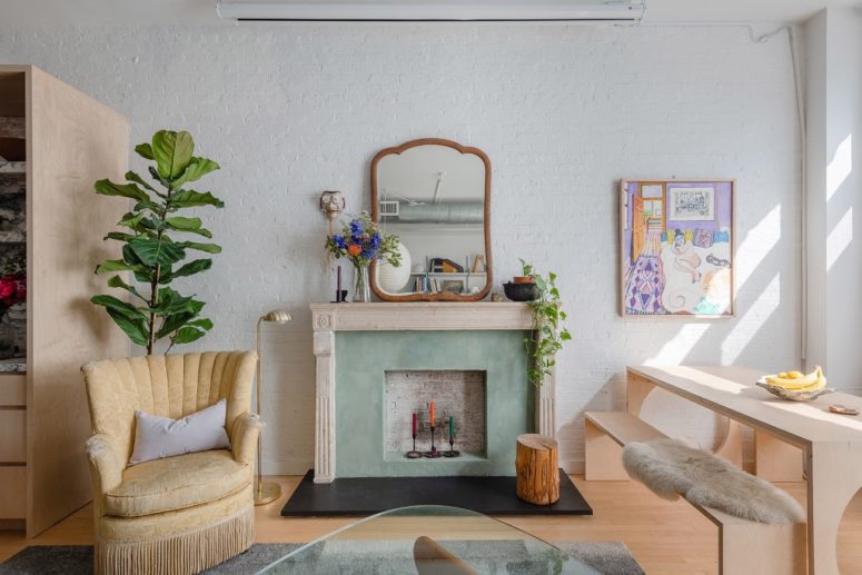 The living room is eclectic and shows off some vintage and refined furniture, decor and potted greenery plus muted colors The living room is eclectic and shows off some vintage and refined furniture, decor and potted greenery plus muted colors
