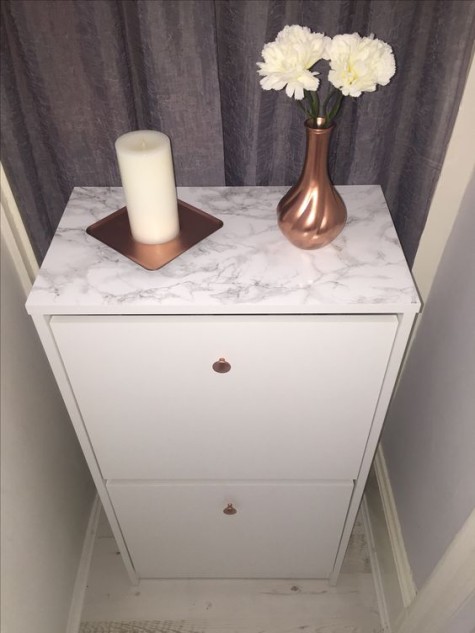 an IKEA Bissa hack done with copper knobs and marble contact paper is a small and stylish piece for any entryway
