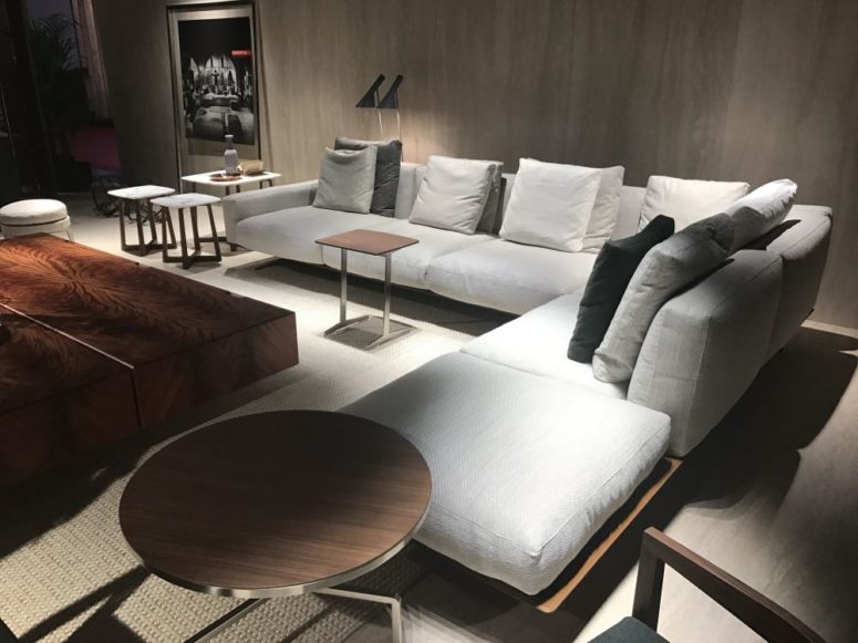 an elegant neutral living room in neutrals, white and various shades of stained wood looks very chic