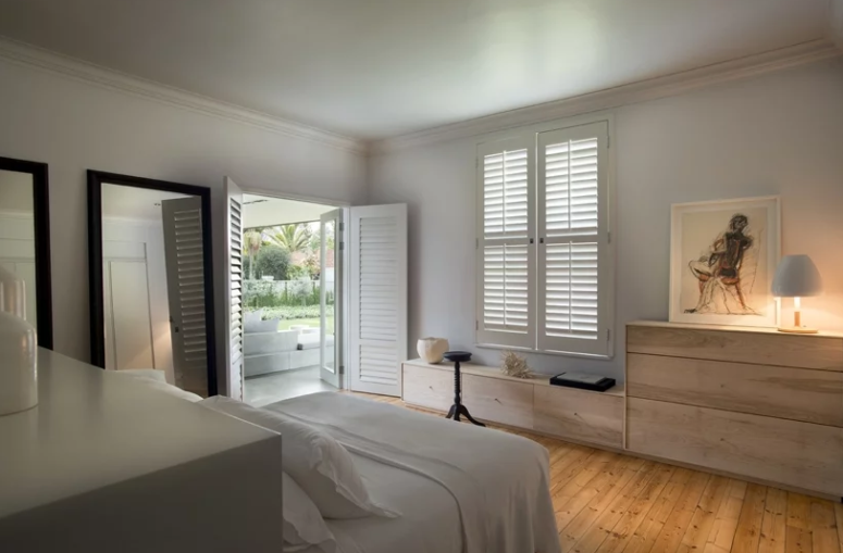 The bedroom is done in neutrals, with sleek furniture and large mirrors, it can be opened to outdoors The bedroom is done in neutrals, with sleek furniture and large mirrors, it can be opened to outdoors