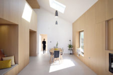04 The dining space is done with a wooden table and upholstered chairs plus pendant lamps over the table