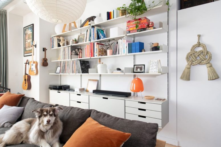 The loft is given much storage space with sleek  plywood cabinets, open shelves and a comfy sofa
