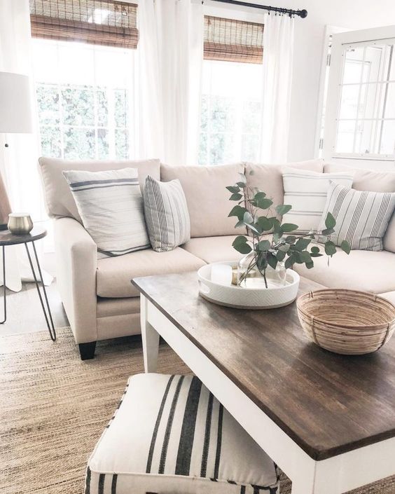 a chic neutral living room with much texture of various materials and fabric and stripes looks very cozy