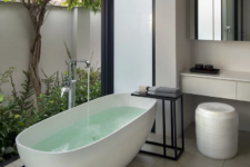 a bathroom with a view to a private courtyard