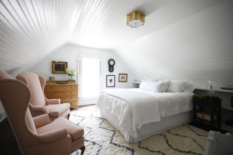 The bedroom is decorated with shiplap, there's vintage furniture and amazing wingback chairs that add charm The bedroom is decorated with shiplap, there's vintage furniture and amazing wingback chairs that add charm