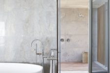 06 The bathroom is also here, with a shower space and clad with grey tiles