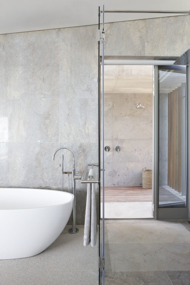 The bathroom is also here, with a shower space and clad with grey tiles