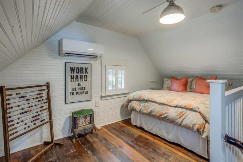 The guest bedroom is a small attic space with a decorative hearth table, a small bed and a little window with shutters The guest bedroom is a small attic space with a decorative hearth table, a small bed and a little window with shutters