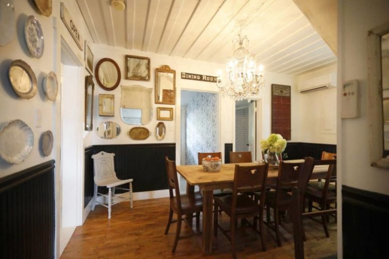 The dining room is done with lots of mirrors and plates on the wall, there's a rustic dining set and a crystal chandelier The dining room is done with lots of mirrors and plates on the wall, there's a rustic dining set and a crystal chandelier