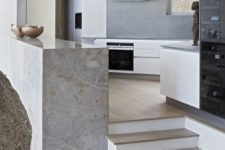 07 The kitchen is done in white and grey, the kitchen island is done in stone and there are cool views