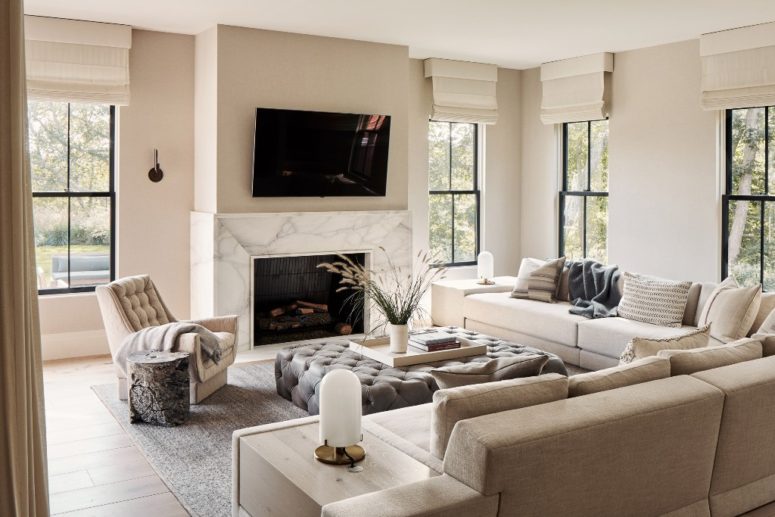 The living room is done with comfy upholstered furniture, a marble clad fireplace and lots of windows The living room is done with comfy upholstered furniture, a marble clad fireplace and lots of windows