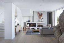 08 The living room is all-white, with firewood storage, geometric details and super elegant furniture