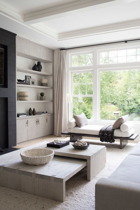 a neutral contemporary living room with plenty of texture, stylish minimalist furniture and dark touches