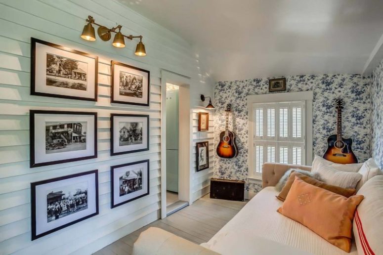 One more guest bedroom features a stylish gallery wall and a couple of guitars