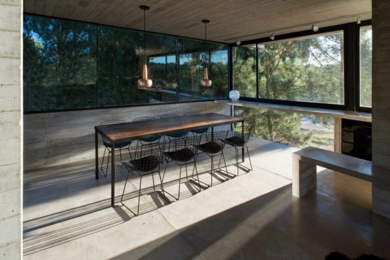 an open ding space design in a minimalist way The dining zone is fully opened to outdoors thanks to glazed walls, which makes having meals here cooler