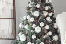 09 a cozy farmhouse Christmas tree with burlap mesh ribbons, snowy pinecones, pearly ornaments and cotton plus a basket