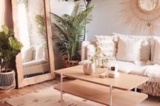 10 a super welcoming and cozy warm neutral living room with light-colored wood and lots of greenery in pots