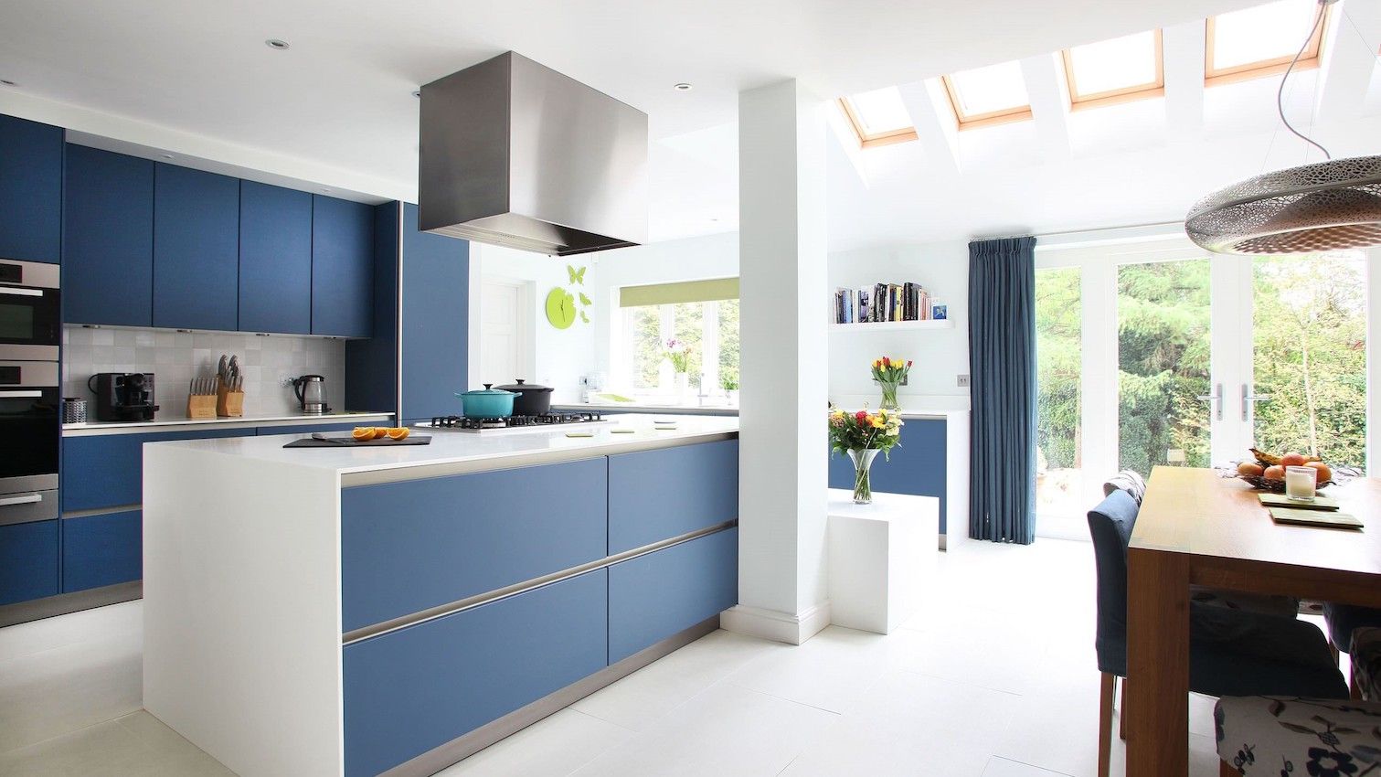 a minimalist classic blue kitchen and matching curtains will add color and chic to your space