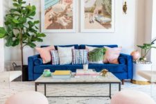 12 a neutral and pastel living room with a classic blue sofa that adds a bright touch and statement to the space