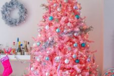 14 a hot pink Christmas tree with neutral, metallic and blue ornaments and lights