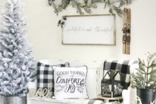 14 buffalo check pillows and a blanket for adding a cozy vintage Christmas feel to your entryway