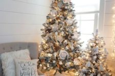 15 a cute duo of flocked Christmas trees with lights, white ornaments and pompoms for a neutral space